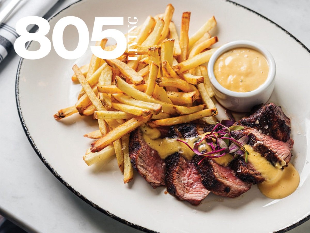 Plate with steak slices topped with sauce, side of golden fries, bowl of dipping sauce, and "805 Living" text.